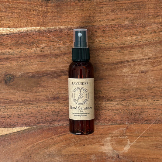 A small bottle of lavender hand sanitizer sits on a large wooden cutting board. 